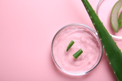 Photo of Flat lay composition with aloe vera leaves and cosmetic gel on pink background. Space for text