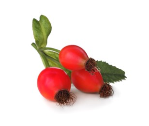 Photo of Ripe rose hip berries with leaves on white background