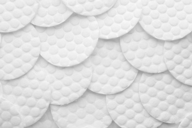 Many cotton pads as background, top view