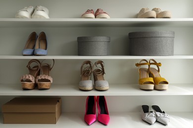 Photo of Storage rack with different stylish women's shoes