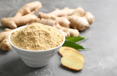 Photo of Dry and fresh ginger on grey table, closeup