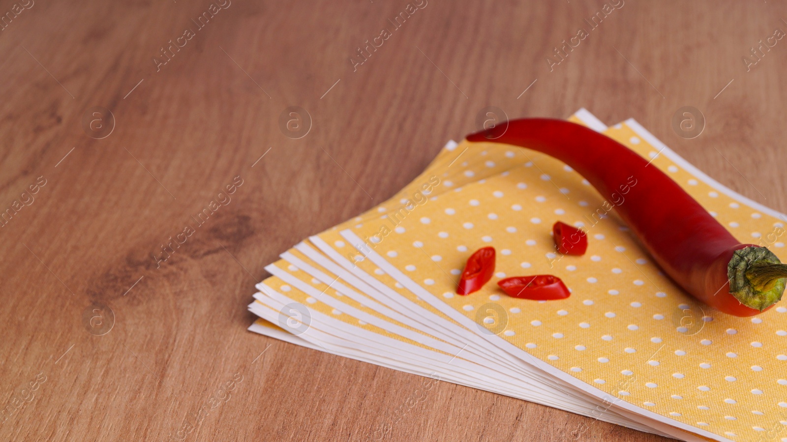 Photo of Pepper plasters and chili on wooden table, closeup. Space for text