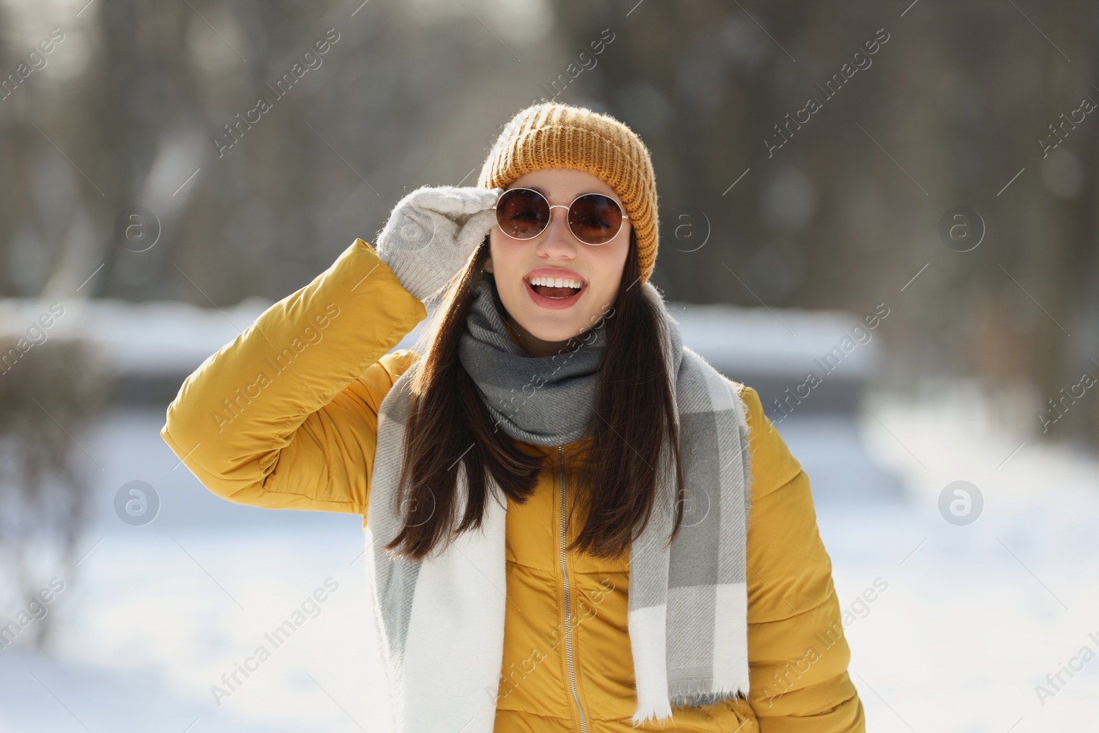 Photo of Portrait of beautiful young woman with sunglasses on winter day outdoors