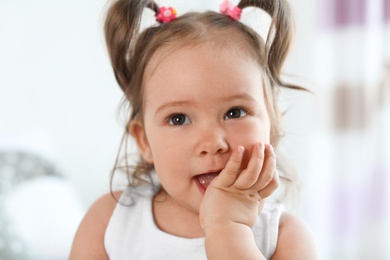 Photo of Adorable little baby girl on blurred background