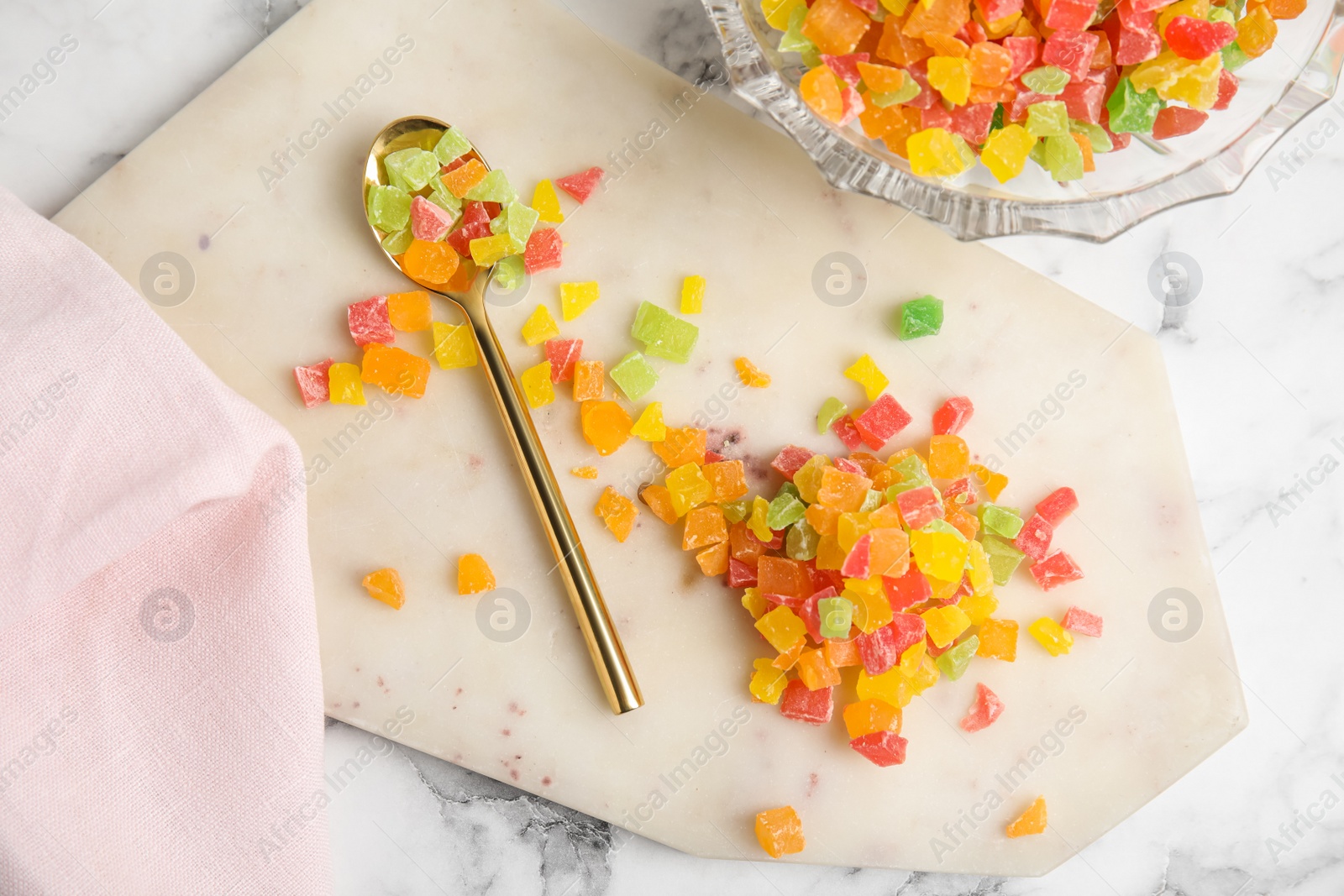 Photo of Mix of delicious candied fruits on white marble table, flat lay