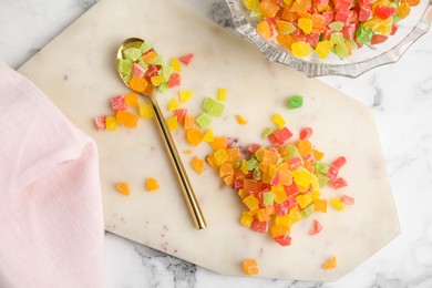 Photo of Mix of delicious candied fruits on white marble table, flat lay