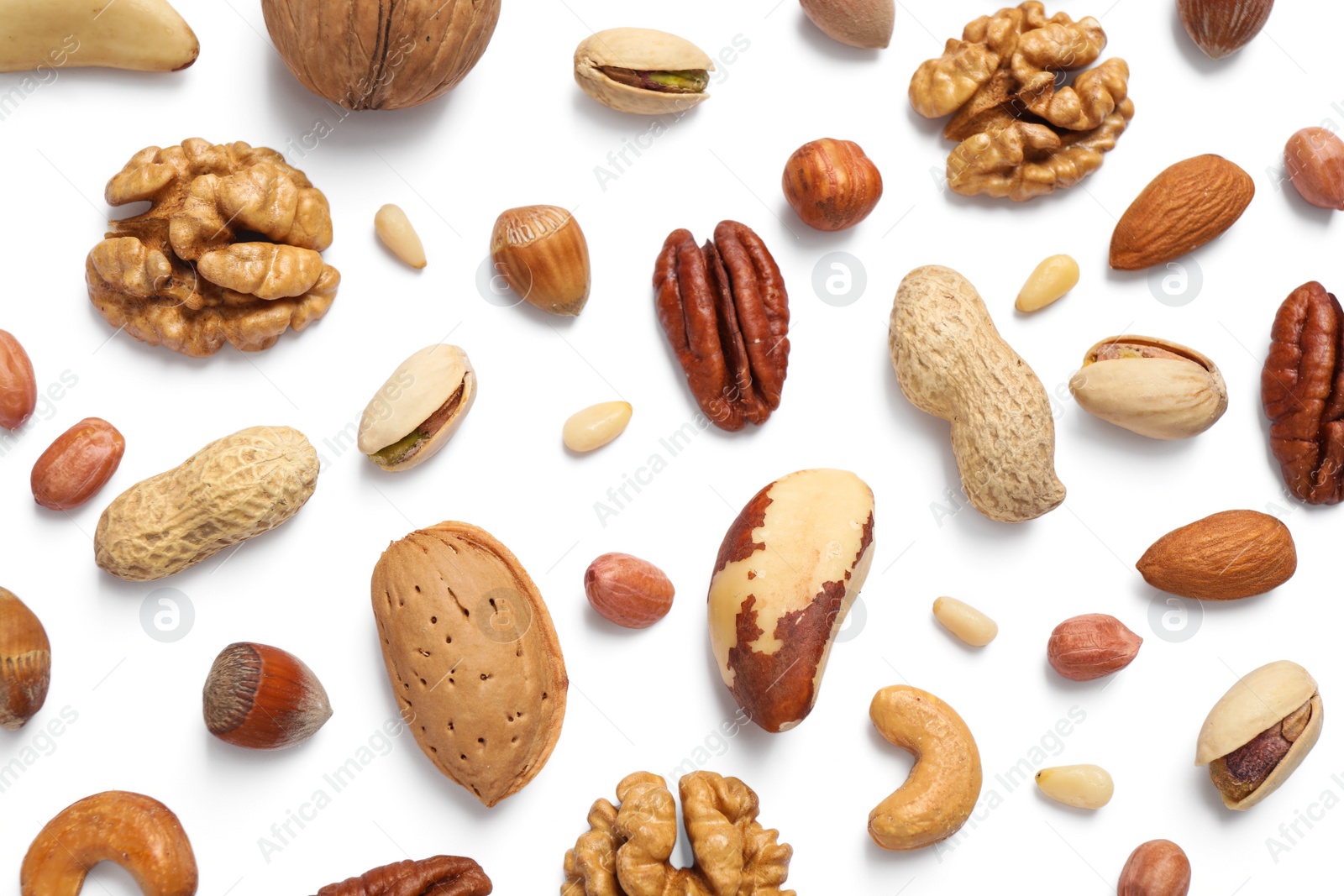 Photo of Different delicious nuts on white background, flat lay