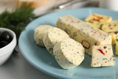 Photo of Tasty butter with herbs and spices on white table, closeup