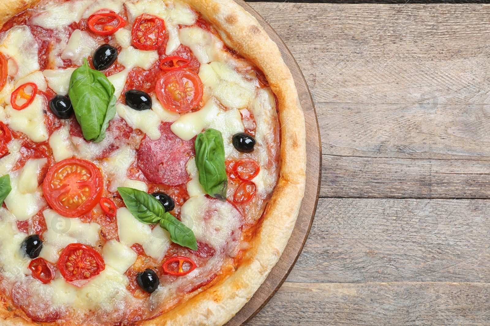 Photo of Delicious pizza Diablo on wooden table, top view