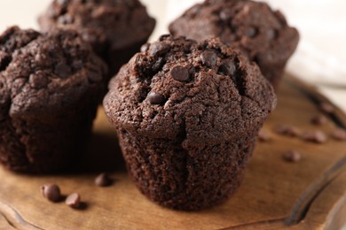 Delicious fresh chocolate muffins on table, closeup