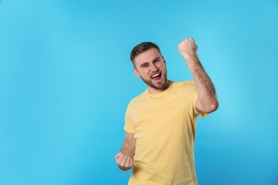 Portrait of emotional young man on color background. Space for text