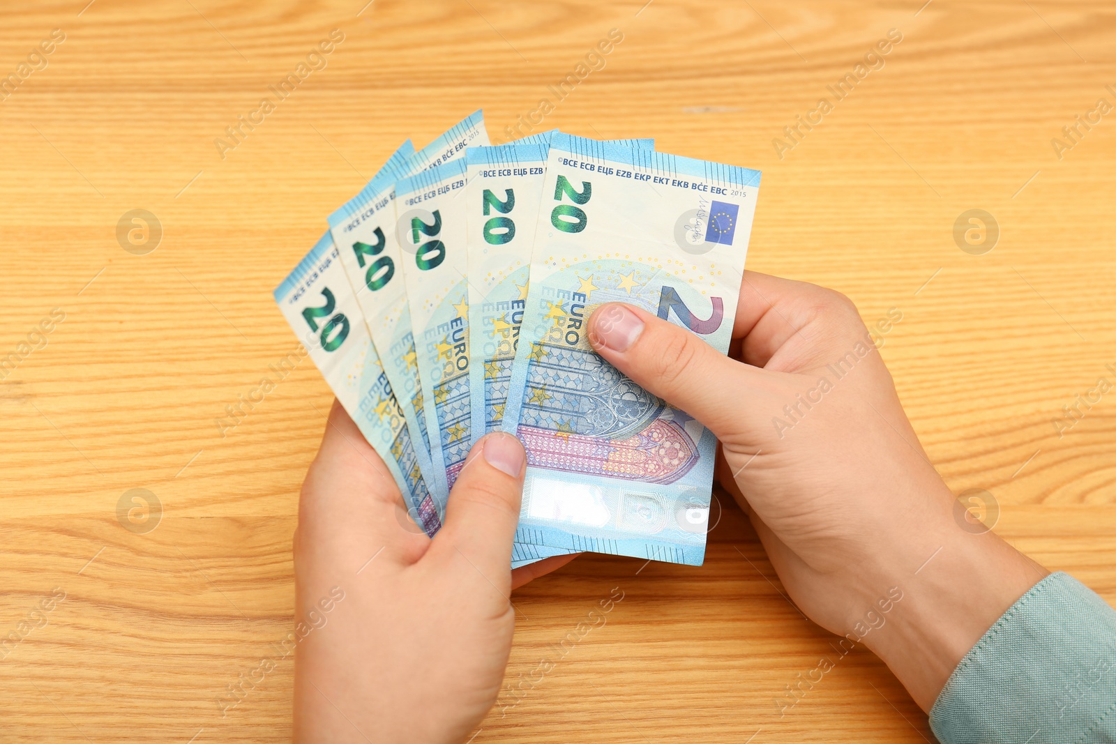 Photo of Man with Euro banknotes at table, top view