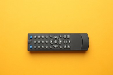 Photo of Remote control on yellow background, top view