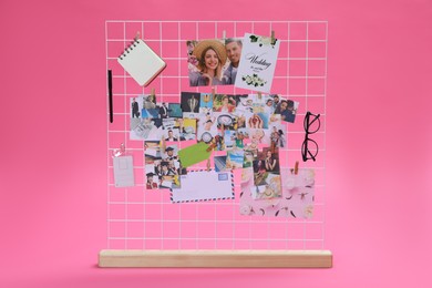 Photo of Vision board with different photos and other elements representing dreams on pink background