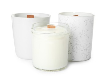 Beautiful candles with wooden wicks on white background