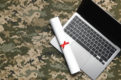 Photo of Laptop and diploma on camouflage background, top view with space for text. Military education