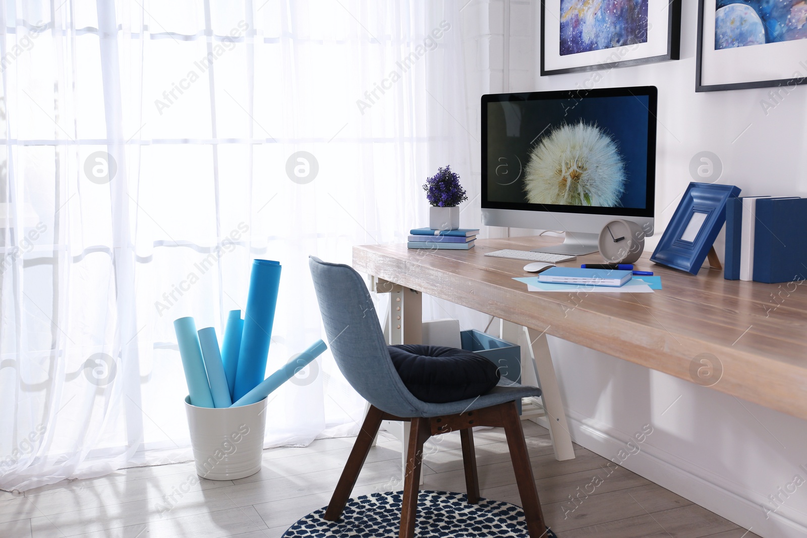 Photo of Modern workplace interior with computer on table