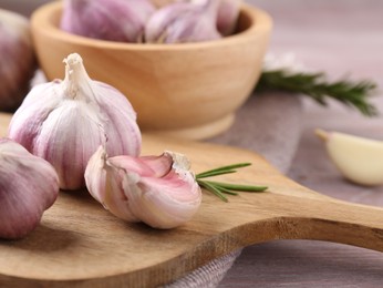 Photo of Bulbs and cloves of fresh garlic on table, closeup