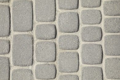 Photo of Pavement with grey tiles as background, top view