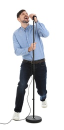 Handsome man singing in microphone on white background