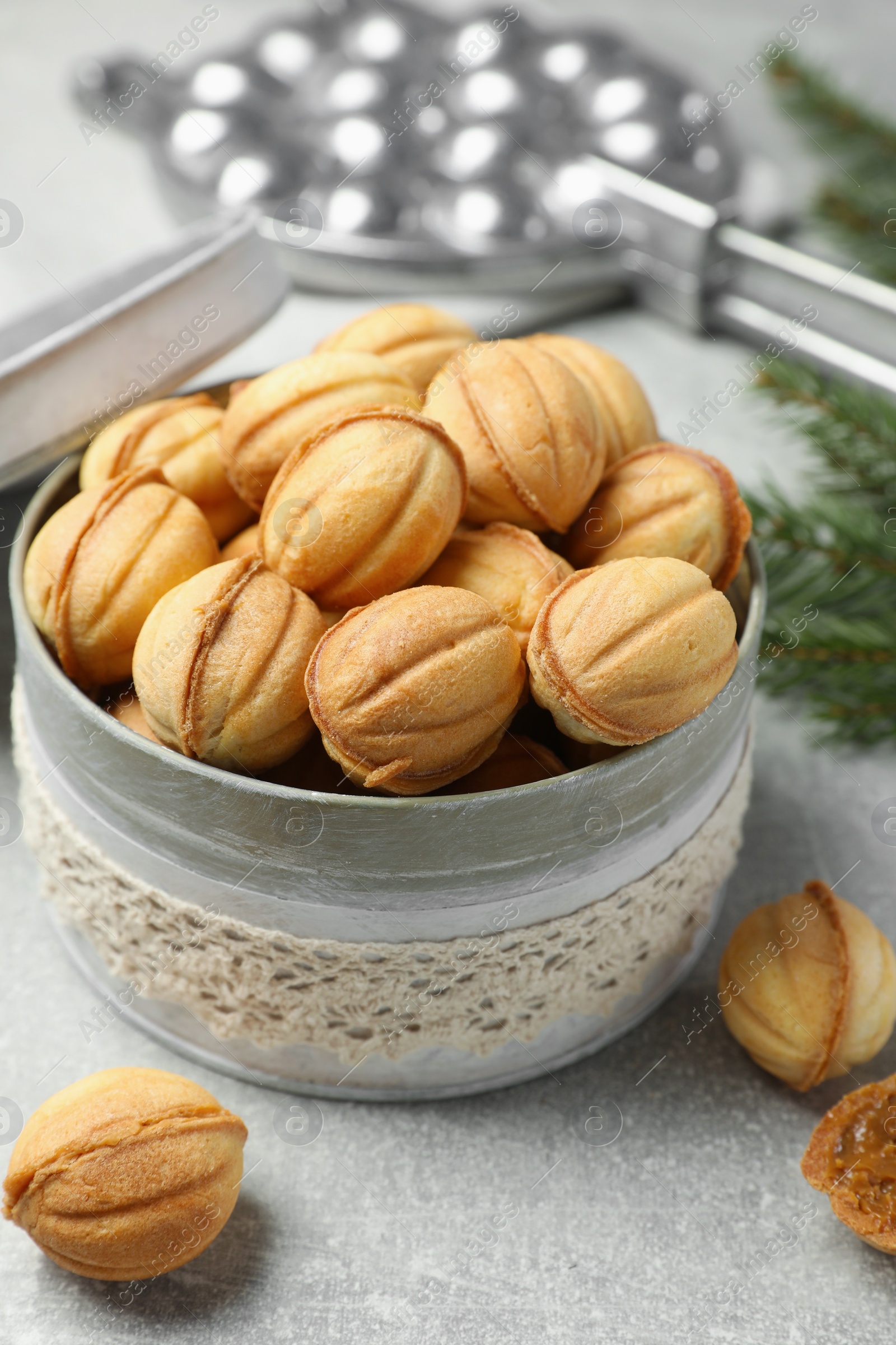 Photo of Delicious nut shaped cookies with boiled condensed milk on light grey table