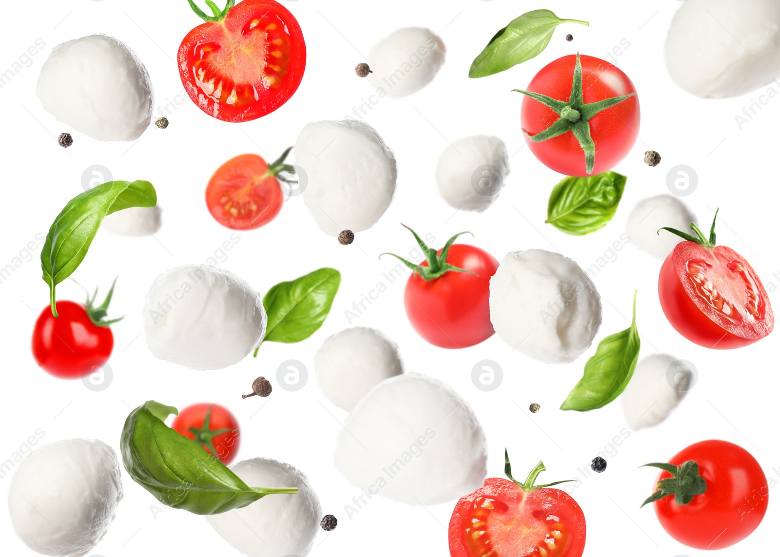 Image of Mozzarella cheese balls, tomatoes, basil leaves and peppercorns for caprese salad flying on white background