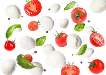 Mozzarella cheese balls, tomatoes, basil leaves and peppercorns for caprese salad flying on white background