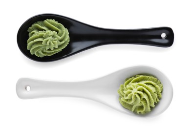 Image of Serving spoons with spicy wasabi paste on white background, top view