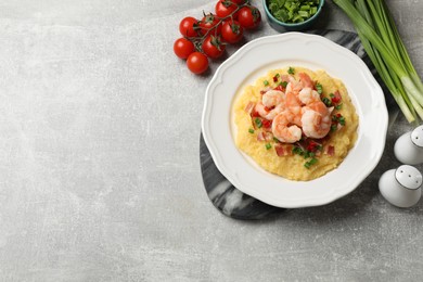 Photo of Plate with fresh tasty shrimps, bacon, grits, green onion and pepper on gray textured table, flat lay. Space for text