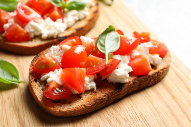 Closeup view of tasty bruschettas on wooden board