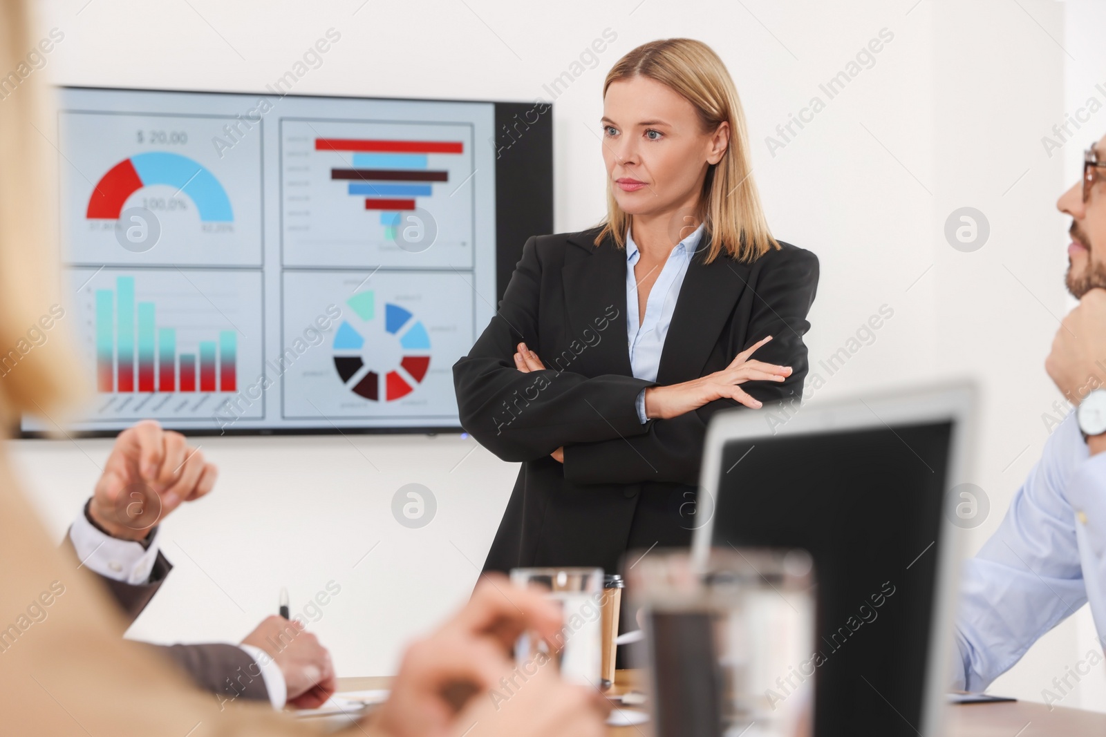 Photo of Businesswoman having meeting with her employees in office