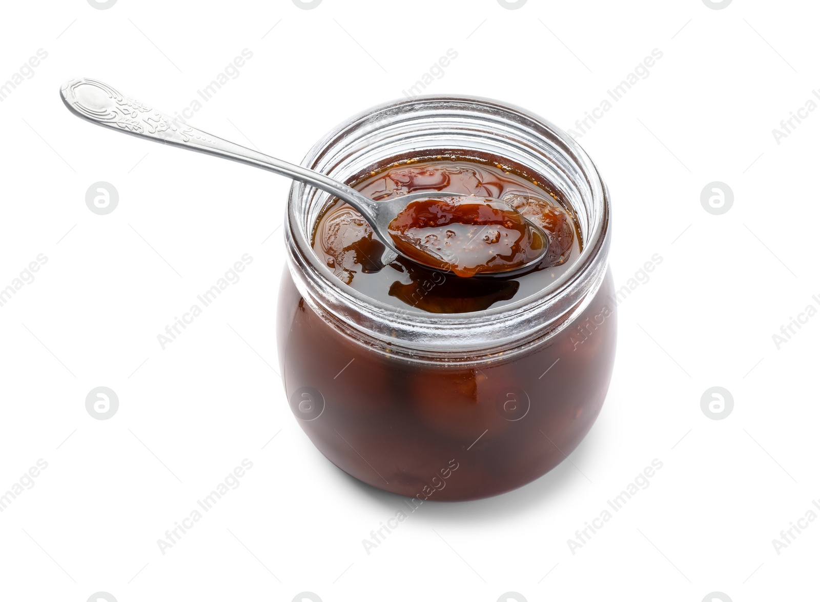Photo of Jar of tasty sweet fig jam and spoon isolated on white