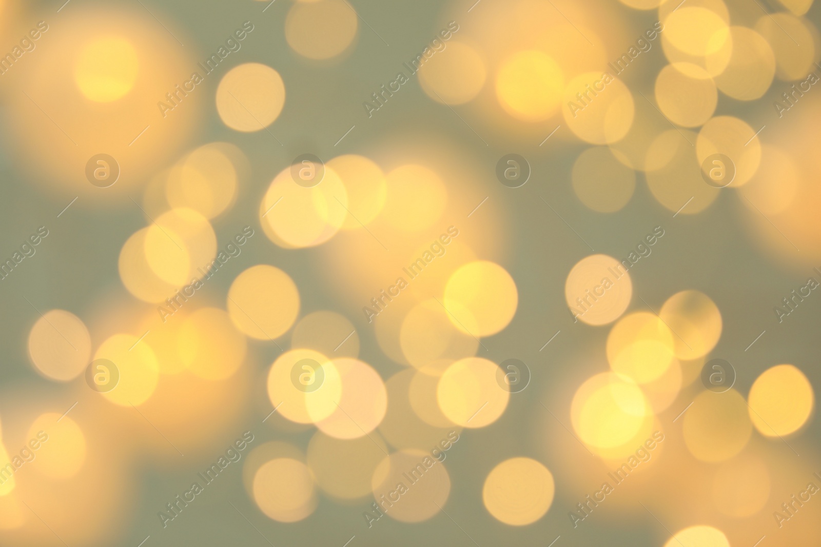 Photo of Blurred view of shiny gold lights. Bokeh effect