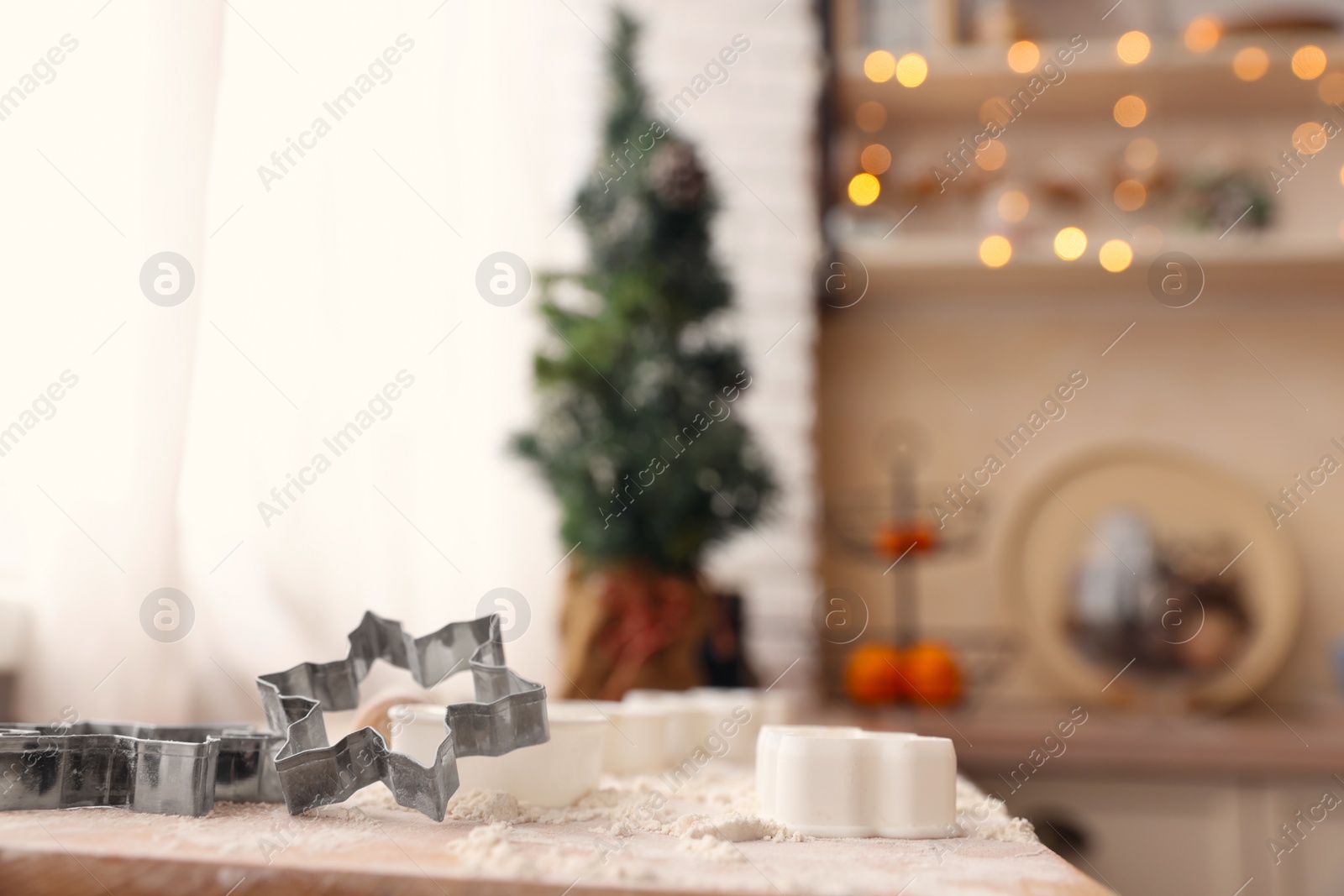 Photo of Cookie cutters on wooden table in kitchen, space for text