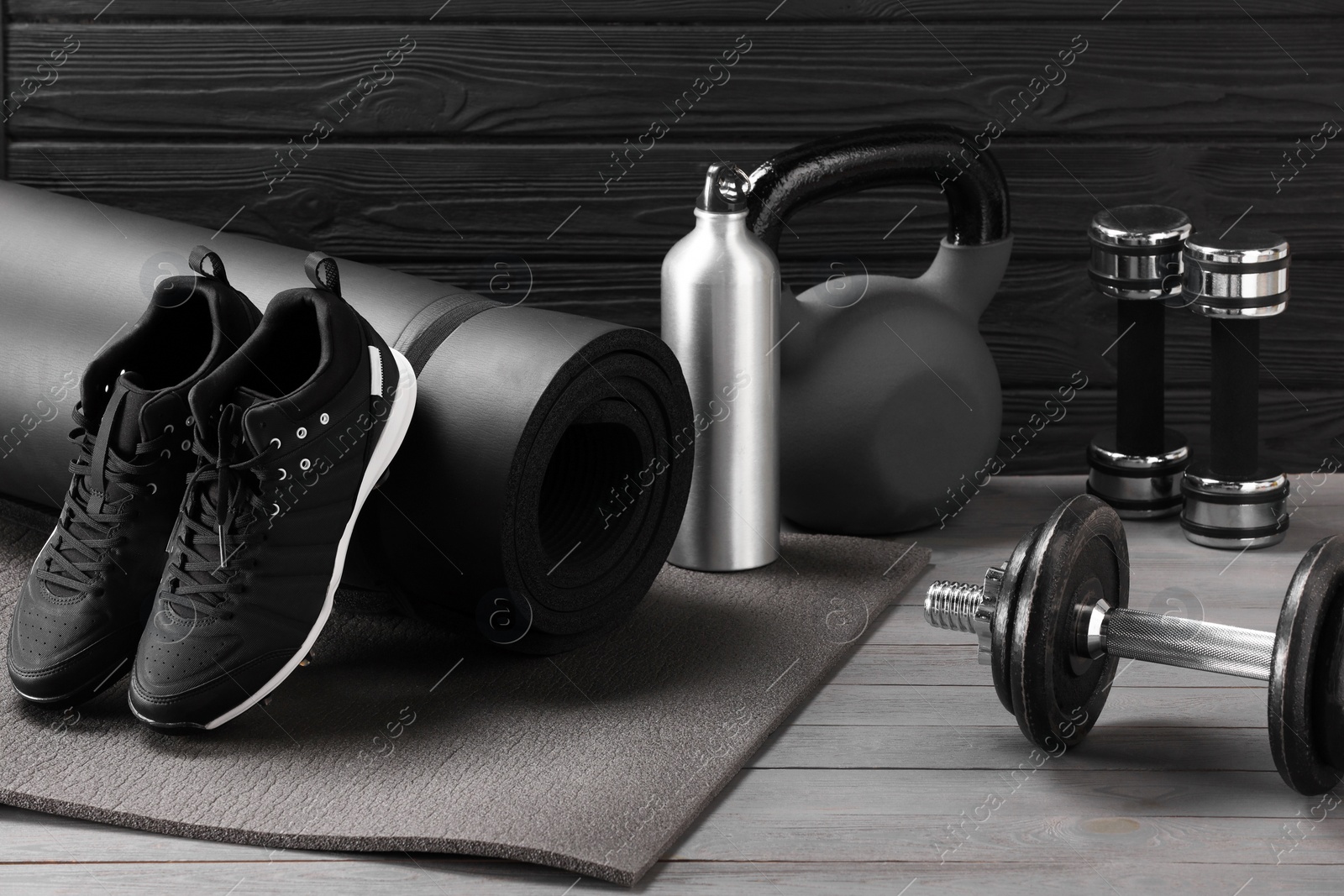 Photo of Many different sports equipment on grey wooden table