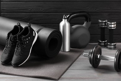 Photo of Many different sports equipment on grey wooden table