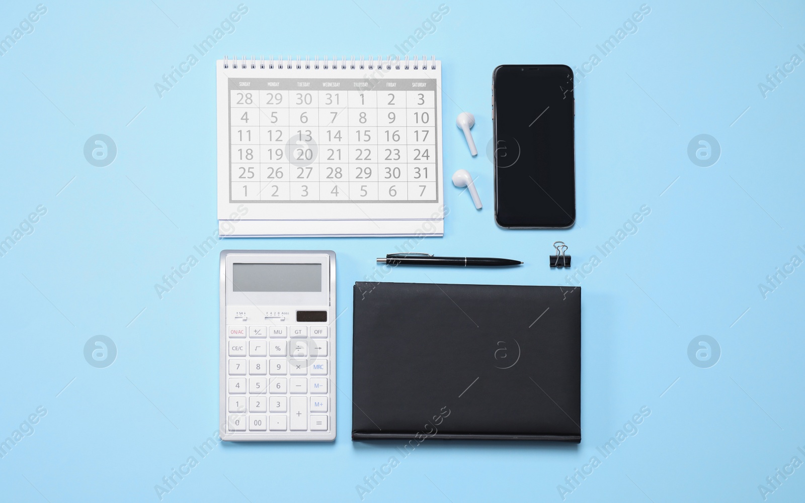 Photo of Smartphone and stationery on light blue background, flat lay