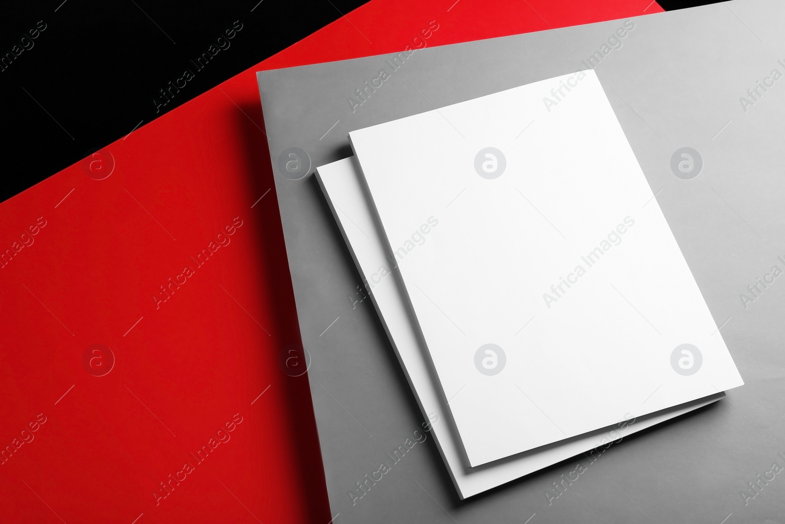 Photo of Empty stacks of papers on color background. Mockup for design