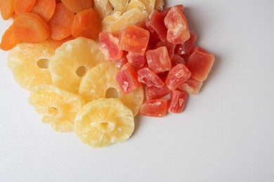 Pile of different dried fruits on white background, top view