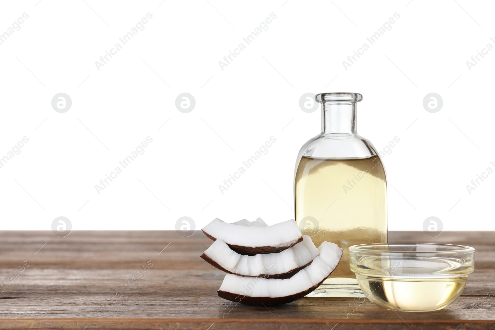 Photo of Composition with natural organic coconut oil on wooden table against white background. Space for text