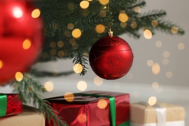 Photo of Red baubles hanging on Christmas tree indoors