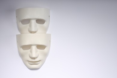 Theater arts. Two masks on white background, top view. Space for text