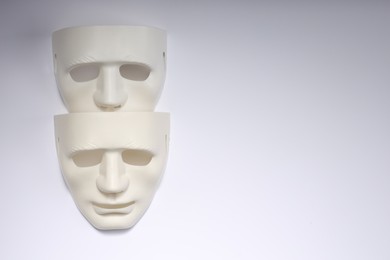 Photo of Theater arts. Two masks on white background, top view. Space for text