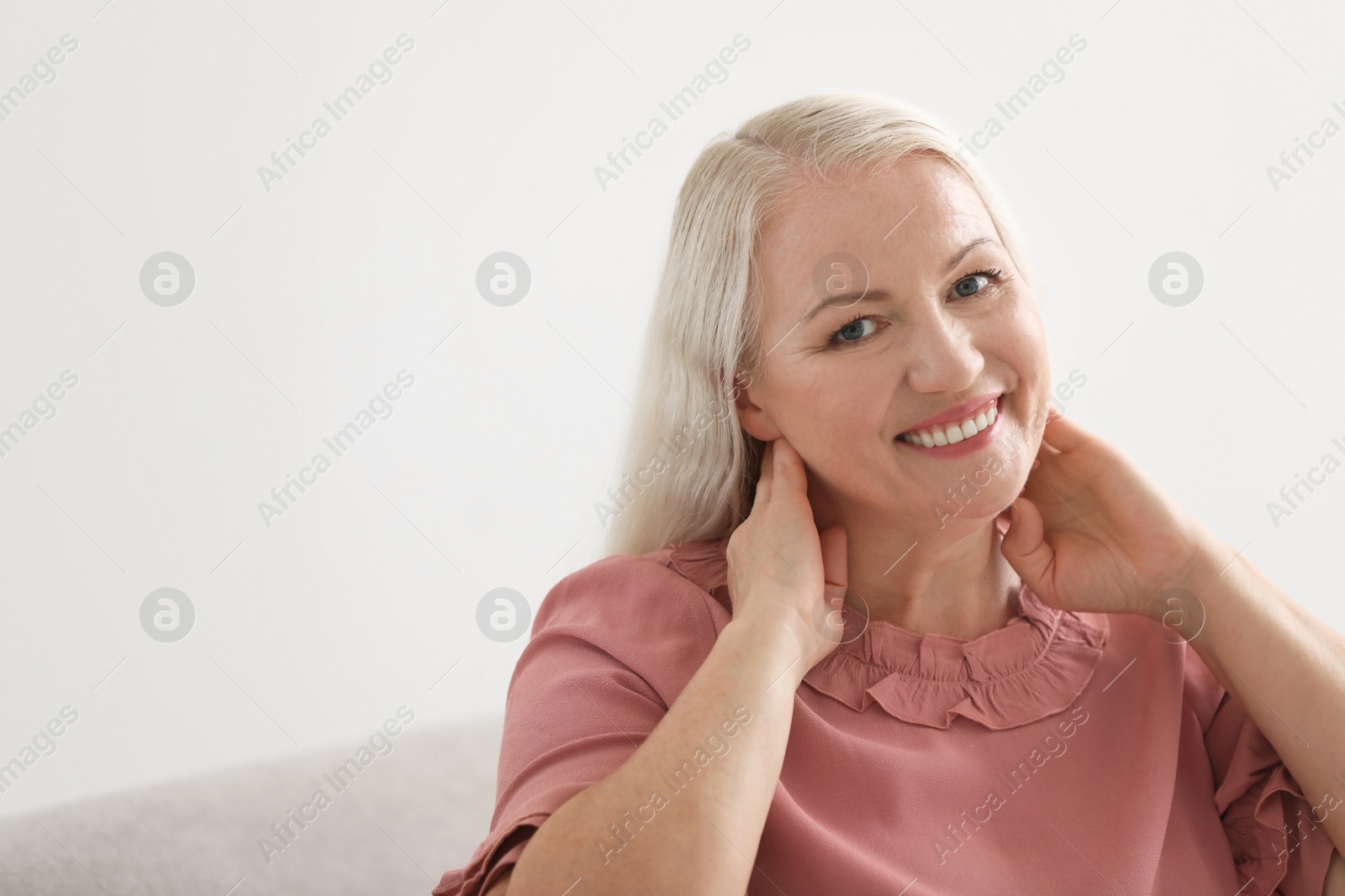 Photo of Portrait of beautiful older woman against light background with space for text