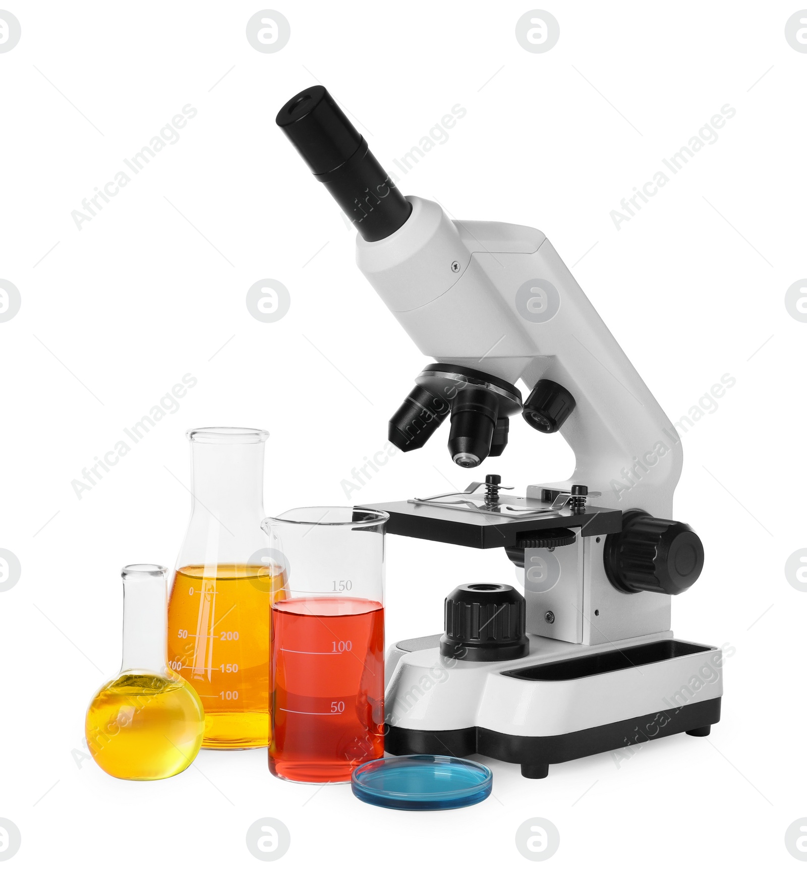 Photo of Laboratory glassware with colorful liquids and microscope isolated on white