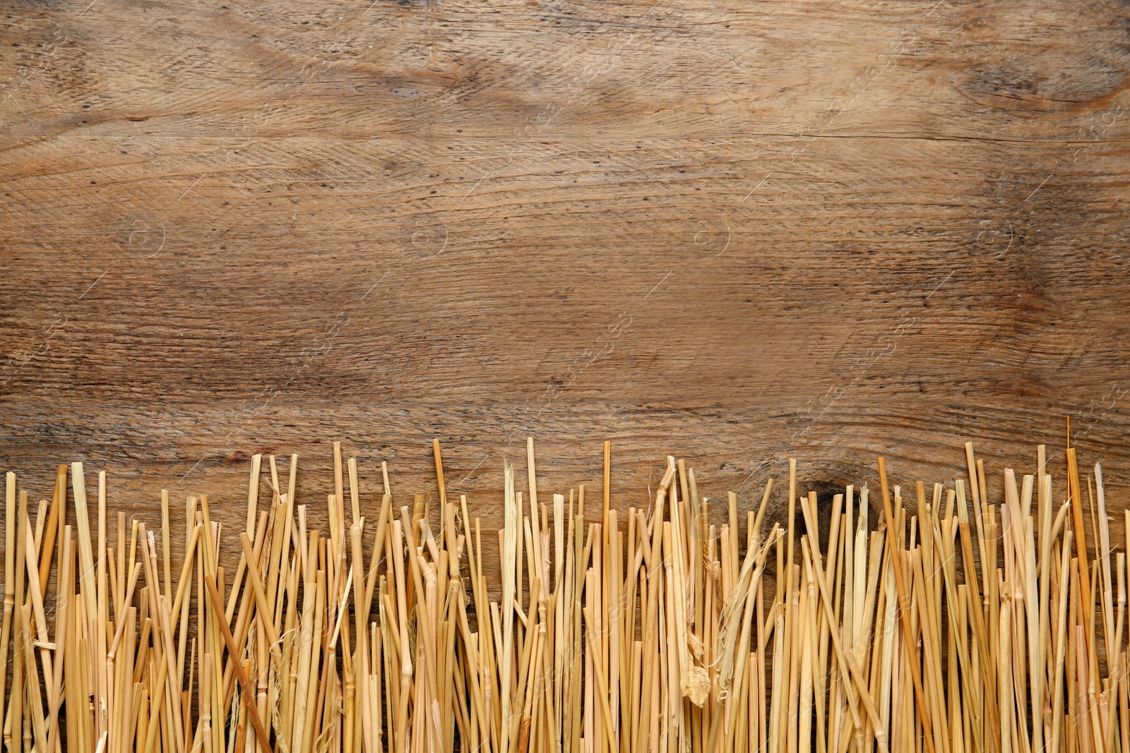 Photo of Dried hay on wooden background, flat lay. Space for text