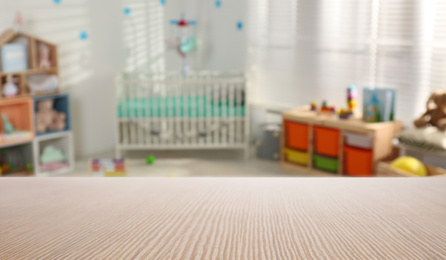 Image of Empty wooden table in baby room interior