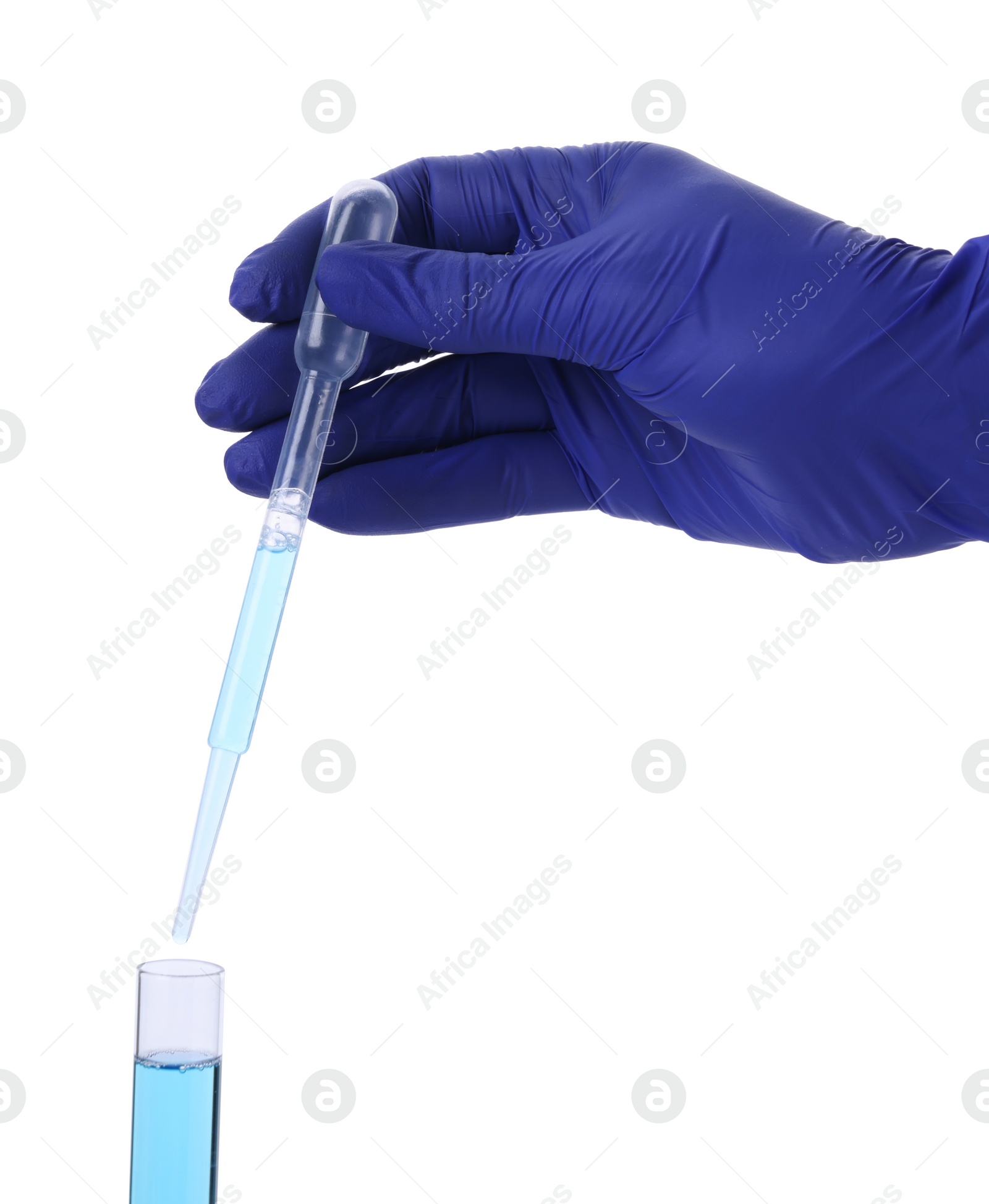 Photo of Scientist dripping liquid from pipette into test tube on white background, closeup