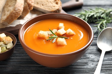 Bowl of tasty sweet potato soup served on table