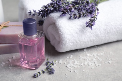 Cosmetic products and lavender flowers on light table